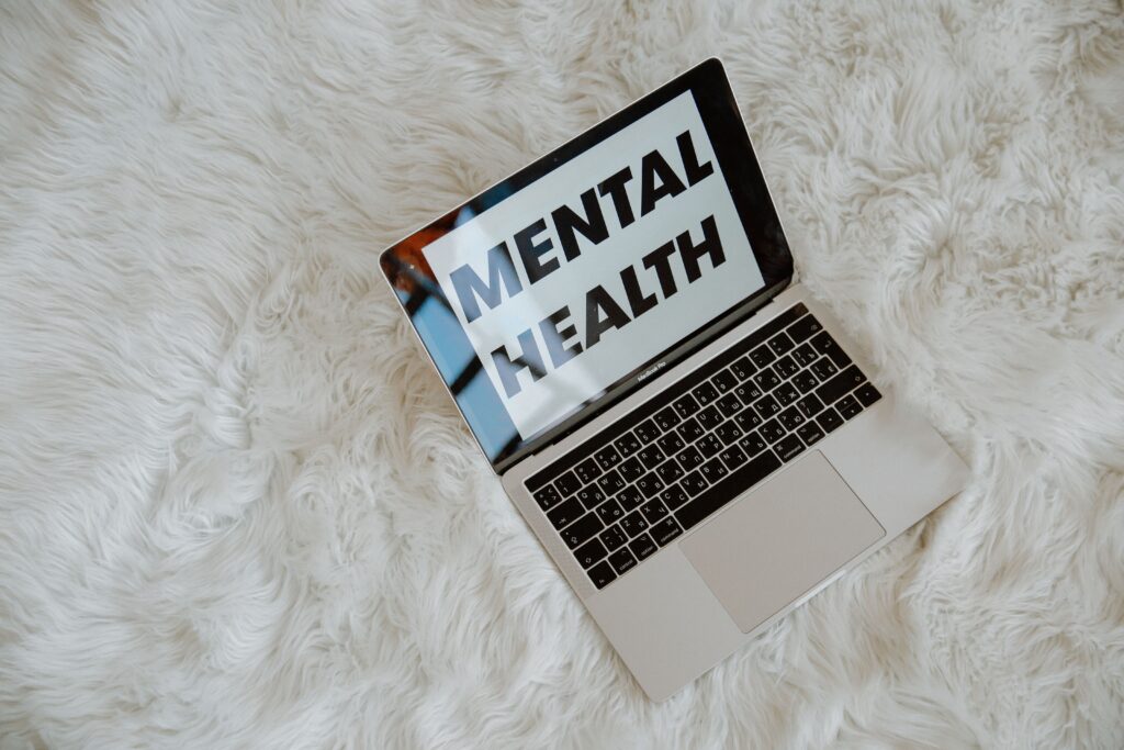 Laptop with 'mental health' text on screen