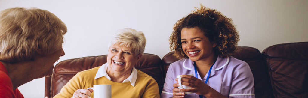 A carer having a cup of tea with clients