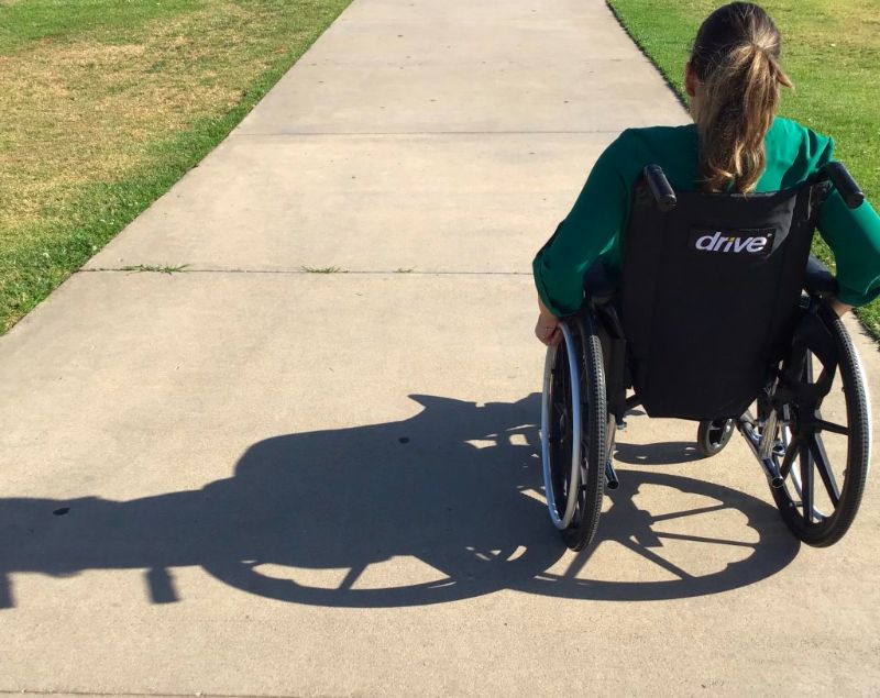 Wheelchair user on a pavement