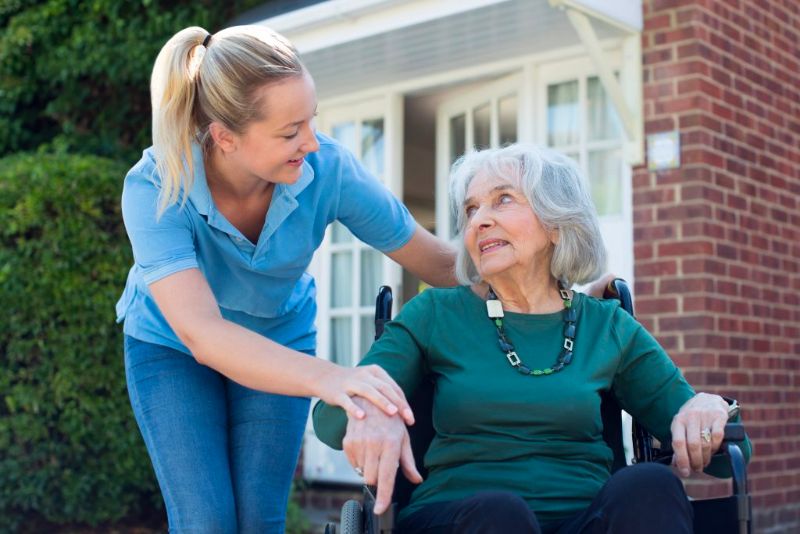 Carer with a lady on a wheelchair