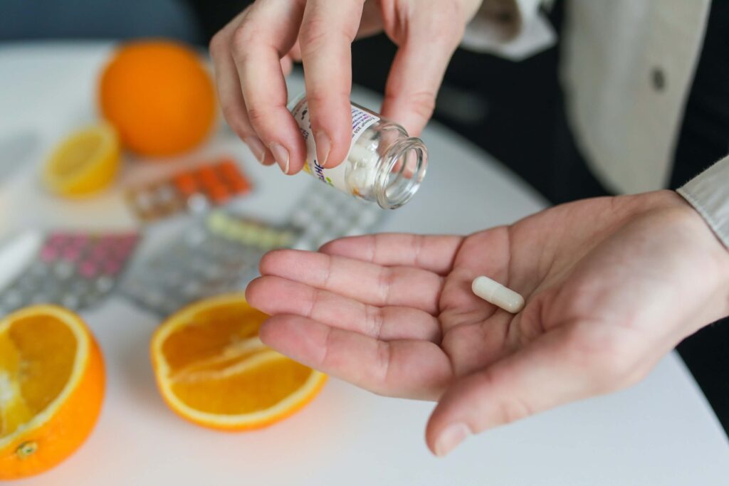 Carer getting a pill out of a pot