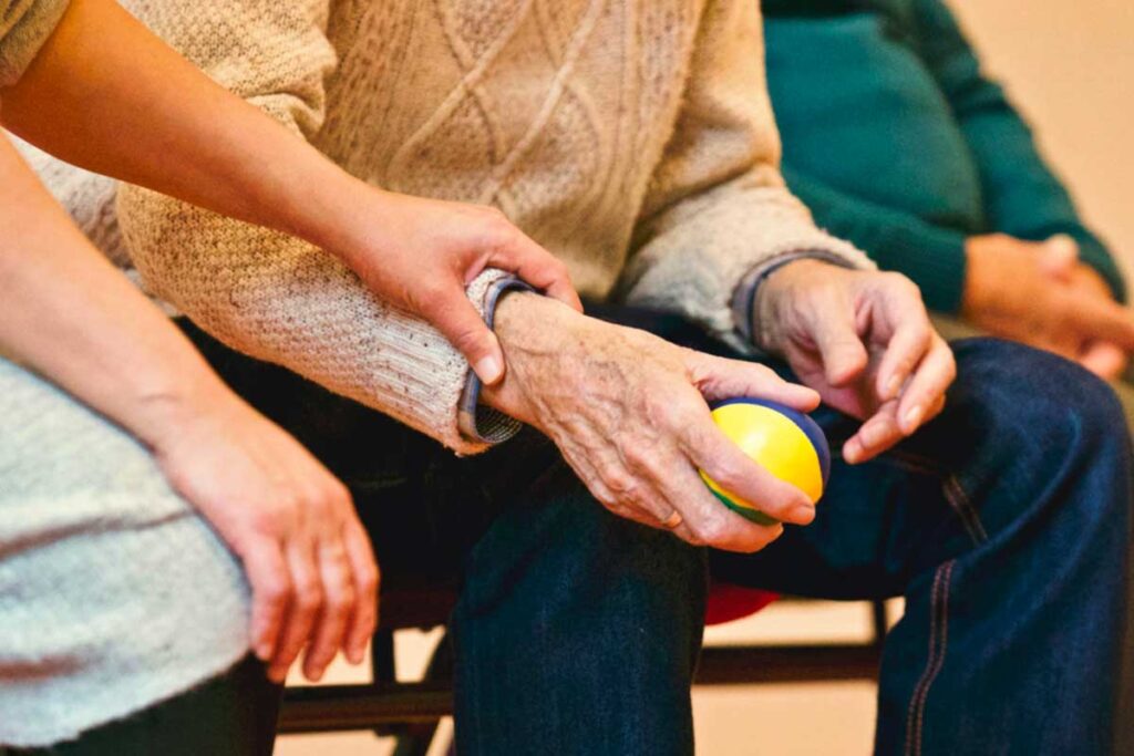 Elderly man holding a ball