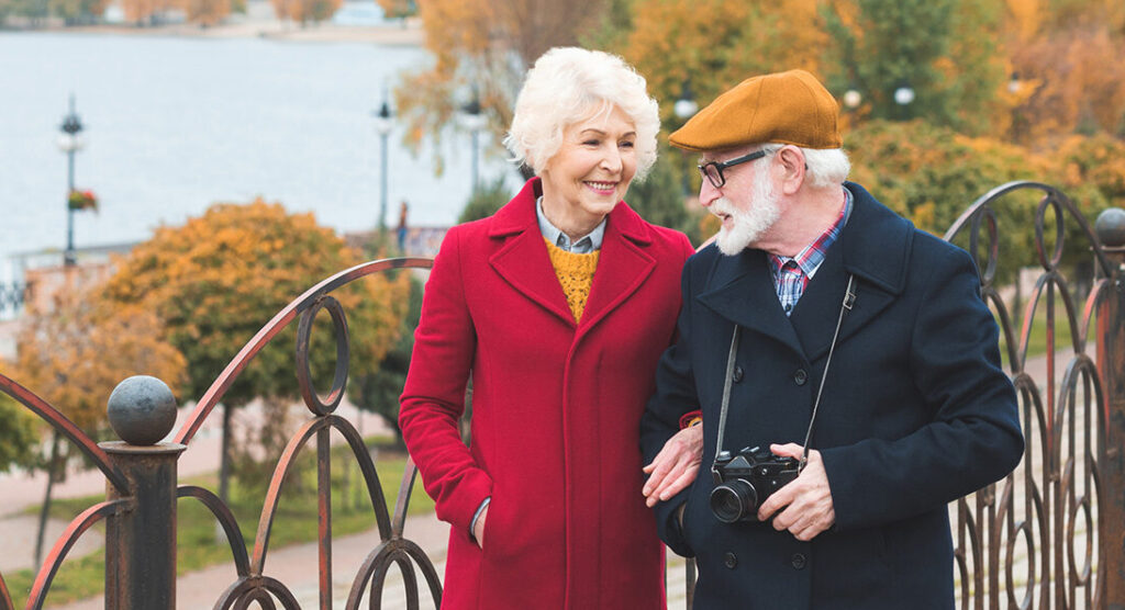 Elderly couple walking through park