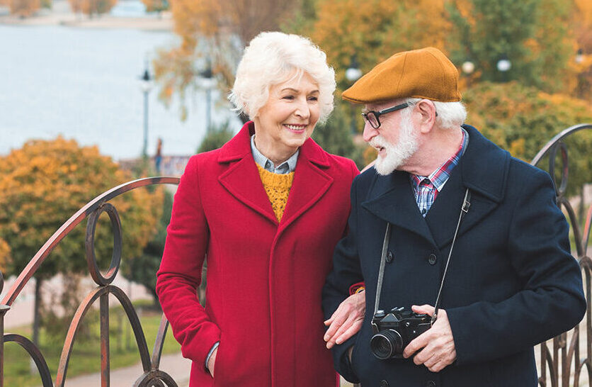 Elderly couple walking through park